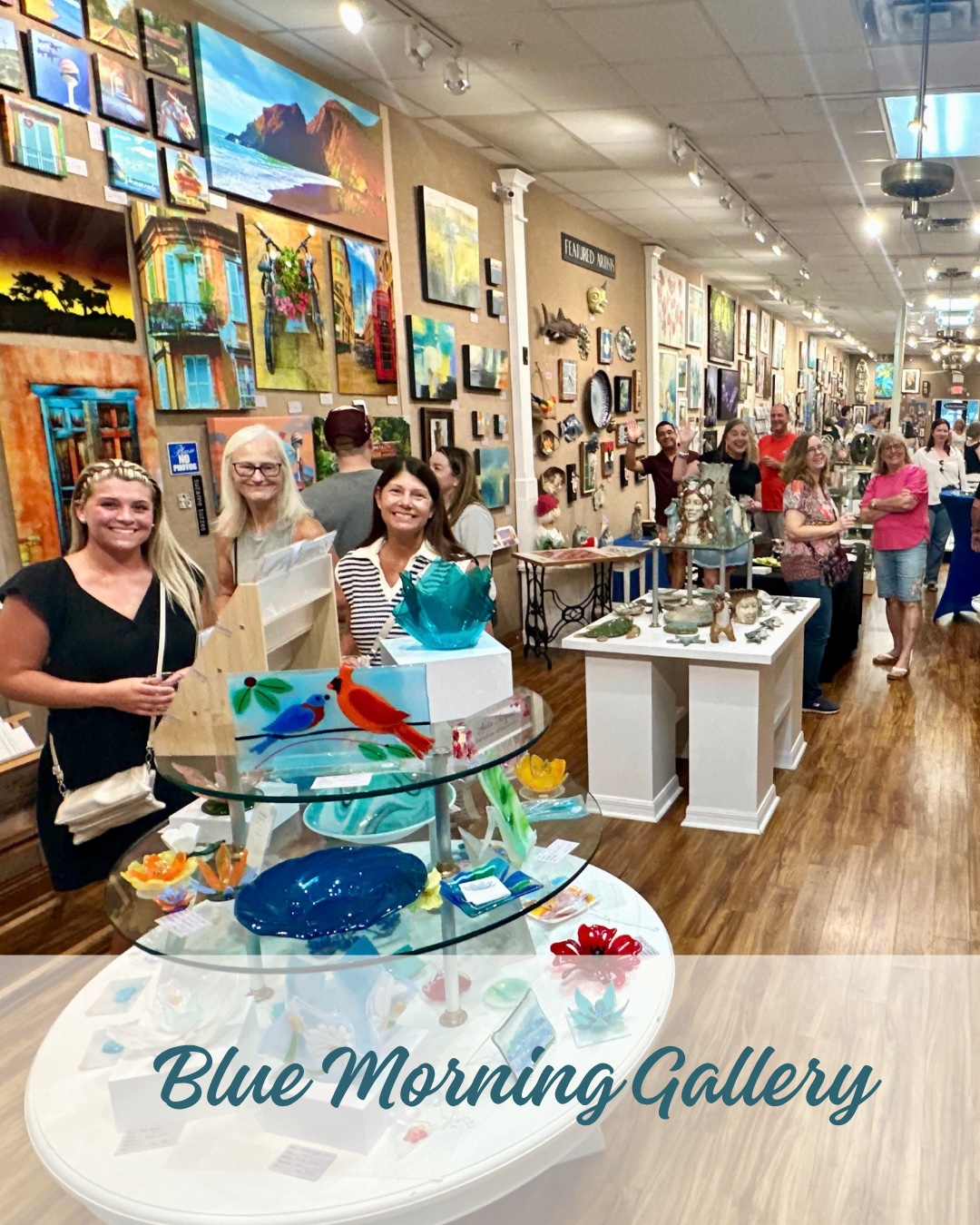 Visitors and artwork inside Blue Morning Gallery during First Fridays