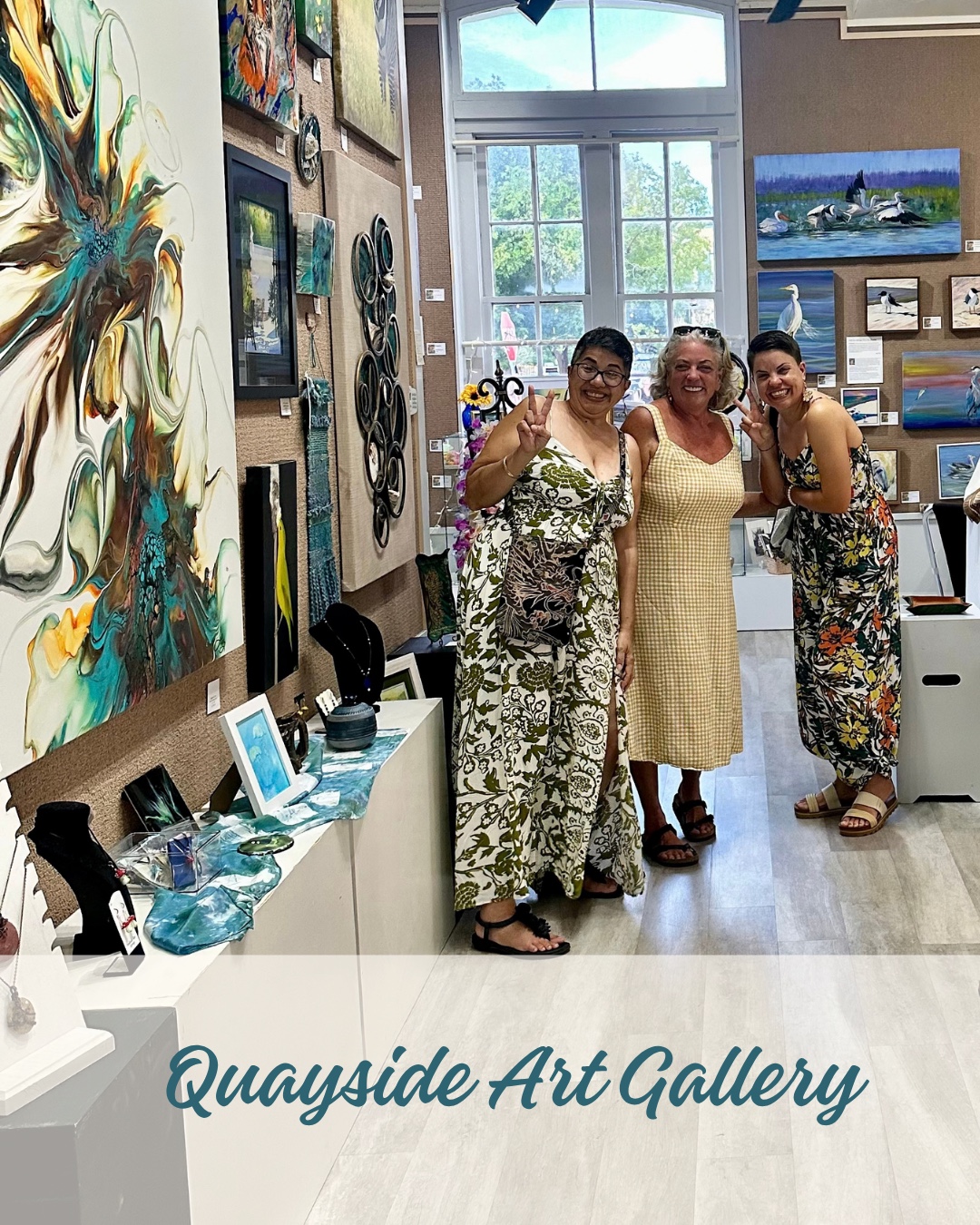 Visitors surrounded by artwork inside Quayside Art Gallery during First Fridays